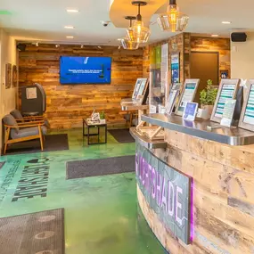 Check-in area at Lightshade dispensary with digital kiosks, seating, and a welcoming atmosphere.