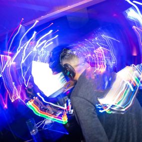 Colorful photo of DJ having fun in high energy enviormet at Oxford social club, the number one Nightclub to enjoy the San Diego Nightlife scene