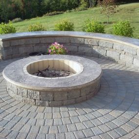 Circular fire pit with low retaining wall which can be used for seating