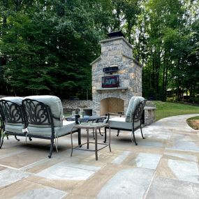 Outdoor living environment with stone patio walkway and fireplace
