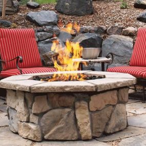 A cozy space for outdoor entertaining with a stone fire pit.