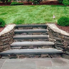Stone retaining wall, steps and landscaping