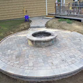 Circular fire pit within circular paver decking