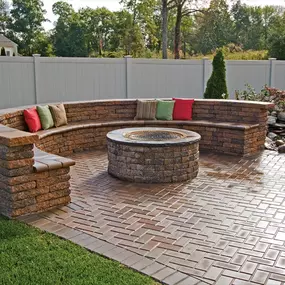 Circular fire pit with round stone bench seating