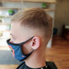Barber shop client in face mask zero fade side view