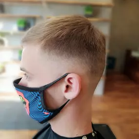 Barber shop client in face mask zero fade side view