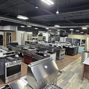 Expansive showroom floor at Art Handler’s Appliance featuring a wide variety of premium kitchen and laundry appliances including ranges, refrigerators, washers, dryers, and grills. The display includes top brands like Café, GE, Viking, and more, designed to help customers visualize their ideal home setup.