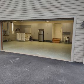 Custom Garage makeover includes new lighting, duel Custom Epoxy flake floor finishes to match interior and exterior of the house.  Wall-to-wall slatwall.  Custom garage cabinets.  Bluetooth enabled multi bike overhead storage.