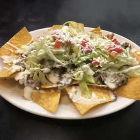 When nachos is in your name, you better do it right. At Nacho's Taqueria & More Authentic Mexican Food in Kennesaw, GA, we load up our chips (made in-house fresh every day!) with your choice of meat, plenty of cheese, and all the right veggies that blend perfectly with the other flavors in your mouth. It's a fiesta! Order yours today by dining in, ordering takeout, or requesting delivery. We're open Monday through Saturday for breakfast, lunch, and dinner.