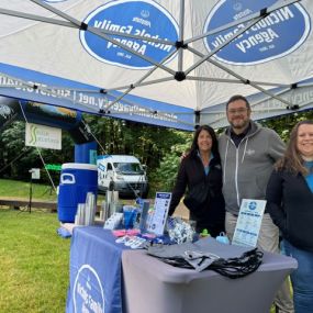 Scott, Stacy & Tracy handing out water at the Sole Sisters Run in June 2024