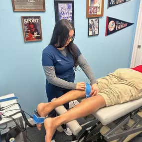 Staff at SunCoast Spine Care in Bradenton Florida applying kinesiology tape