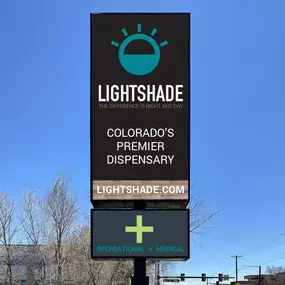 The Lightshade Evans Dispensary sign standing tall, featuring the logo, website, and a message about recreational and medical cannabis.