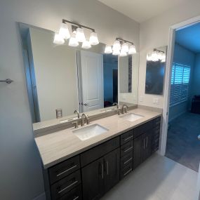 New vanity from Wolf Classic in stain gray finish. Added mirrors, faucets, sinks and wall sconces