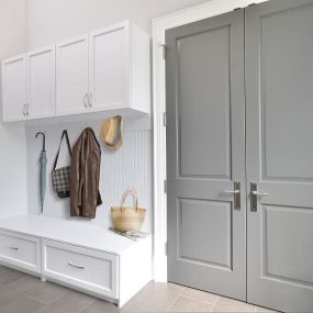 Keep all your outdoor gear tucked behind closed doors with this Entryway Storage Solution. The bench seat provides seating for putting on and taking off shoes, encouraging your guests to get comfortable, and protecting your house from dirt. #TailoredLiving #FreeConsultation #EntrywayOrganization #Ta