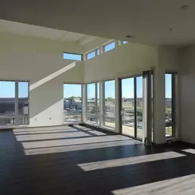 View of empty living room with balcony and wood planking floor