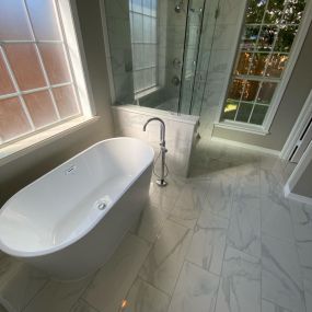 Free standing soaking tub with open tile shower