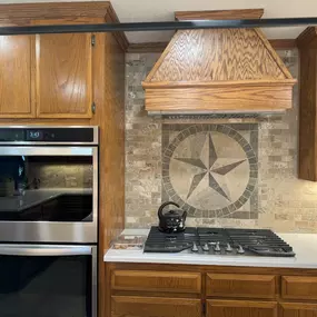Kitchen Refresh involved replacing countertops and adding new backsplash with medallion