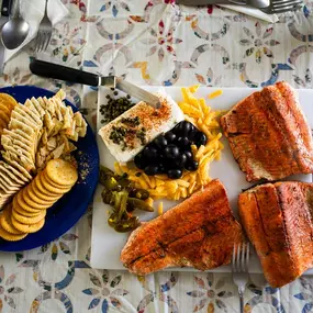 Kanektok River Cuisine during a Float Trip with High Country Guide Service in Boone, NC including fresh-caught salmon and appetizers.