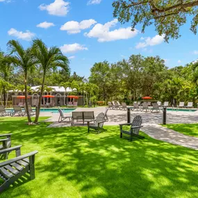 Turf Pool Area with Seating and Corn Hole