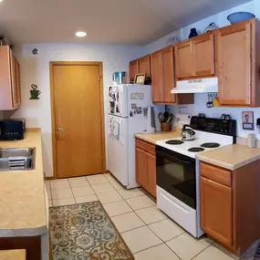 Woodsview Apartments Galley Kitchen with maple cupboards