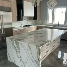 This dramatic quartz waterfall installation leaves us speechless! Ready to add some drama to your kitchen? Contact Exquisite Stone today for a free estimate!