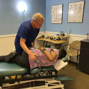 Dr. Timothy Cymanski providing a chiropractic adjustment to a patient