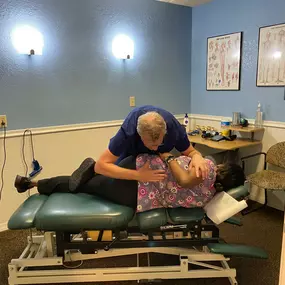 Dr. Timothy Cymanski providing a chiropractic adjustment to a patient