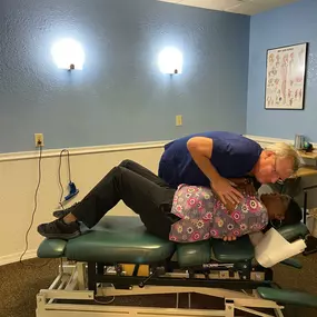 Dr. Timothy Cymanski providing a chiropractic adjustment to a patient