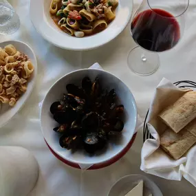 Nino's Italian Cuisine Restaurant Antipasti Dishes Calamari, Mussels, Pasta with Fresh Bread and Red Wine