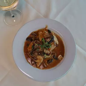 Nino's Authentic Italian Cuisine Dish with Eggplant, Marsala wine sauce, melted mozzarella.