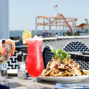 Indulge in our famous seafood tacos while enjoying the vibrant energy of the boardwalk and seaside breeze.