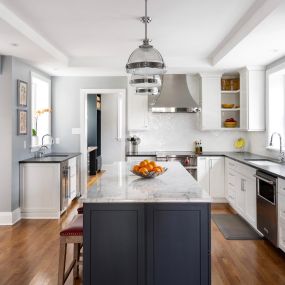 This whole house remodeling project in Ardmore touched every part of this home including the kitchen shown here. Featuring Omega cabinets, soapstone counters and marble counters, hardwood flooring, and stainless appliances, this kitchen had no stone left unturned.