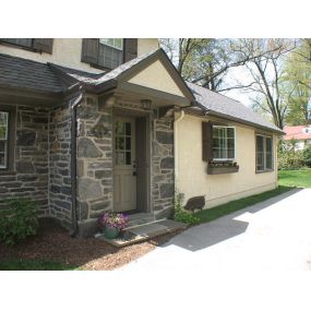 Dutch Colonial kitchen addition and whole house remodel in Wynnewood. New stone entrance portico with new Dutch door.