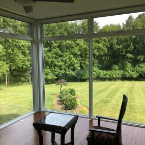 Sunroom / breakfast room conversion in Malvern, PA. The lines between outdoors and indoors are erased with the floor to ceiling Pella windows which include electrically operated transom awning windows at the top.