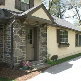 Dutch Colonial kitchen addition and whole house remodel in Wynnewood. New stone entrance portico with new Dutch door.