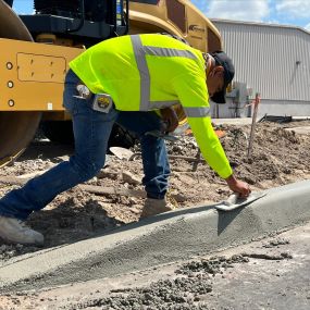 Concrete crewman perfecting curb.