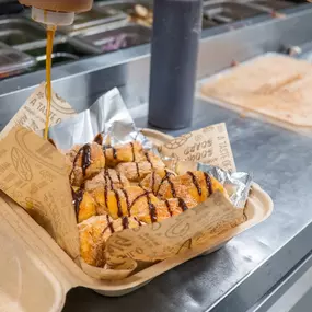 You’ve Gotta Save Room for These! Hawaiian Bread Balls Rolled in Cinnamon Sugar, Served with Vanilla Ice Cream, Drizzled with Caramel & Chocolate Syrup.