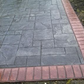 Stamped patio with a brick border