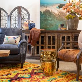 Rustic styled living room with a vibrant rug.