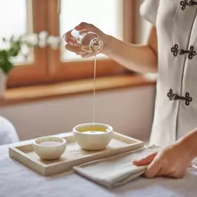 Spa attendant preparing massage supplies