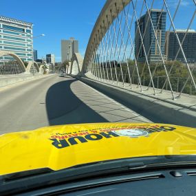 One Hour Air Conditioning and Heating service vehicle driving over the West 7th bridge in Fort Worth TX