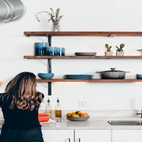 Woman enjoying new kitchen because of DDA Mortgage