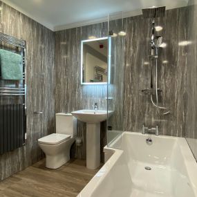 bathroom with L Shaped bath, basin, WC and towel warmer