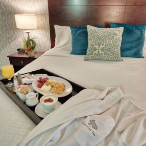 Breakfast tray on a king bed at Somerset Inn