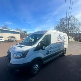 Flick Brothers Electric service van parked under a clear blue sky.