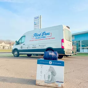 GE stand mixer prize set in front of Flick Brothers Electric van.