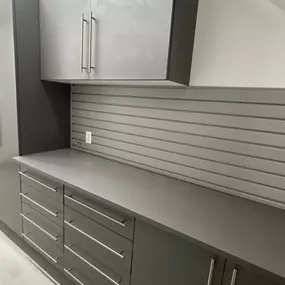 A sleek and functional garage storage setup! ???????? These custom cabinets and slatwall make organization effortless while keeping everything within reach. Ready to upgrade your space? Give us a call! ????