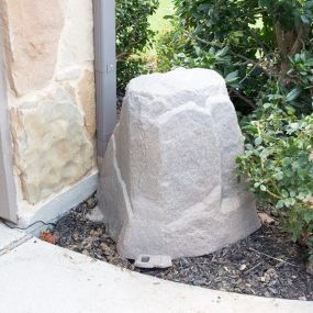 Fake rock covering a water filtration system installation for the whole house. Each water fixture has filtered 