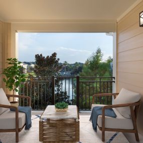 Large balcony overlooking serene lake at Camden LaVina apartments in Orlando, Florida.