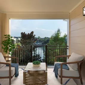 Large balcony overlooking serene lake at Camden LaVina apartments in Orlando, Florida.